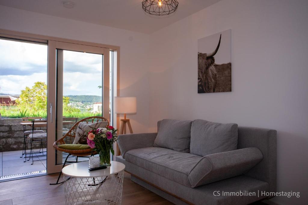 a living room with a couch and a table at Seensucht in Bodman-Ludwigshafen