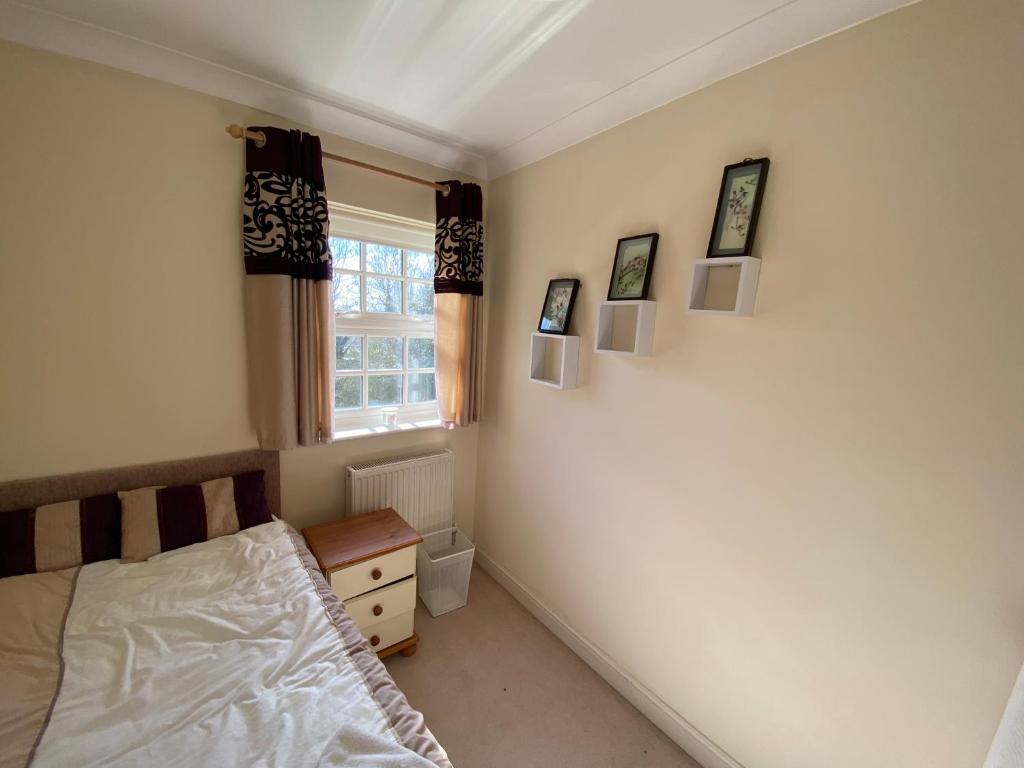 a bedroom with a bed and a window at Woodstock in York