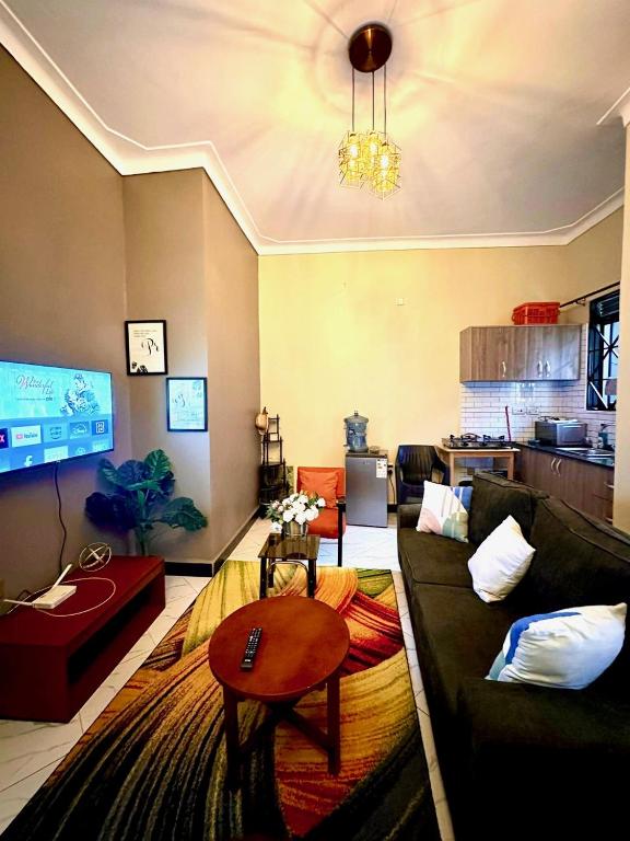 a living room with a couch and a table at Sky world homes in Kampala