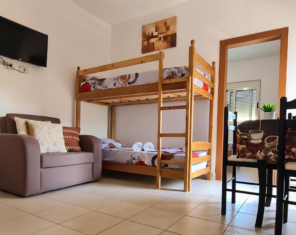 a living room with a bunk bed and a couch at Hotel Gonaj in Velipojë