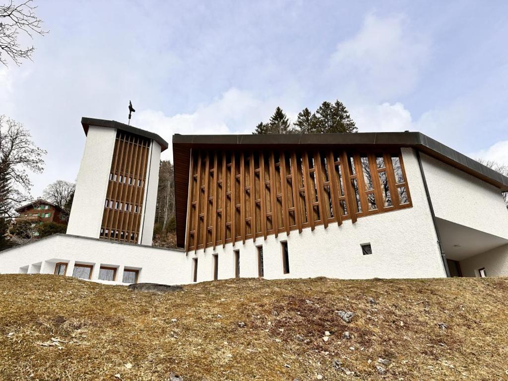 a large white building on top of a hill at Abenteuer Turm in Braunwald