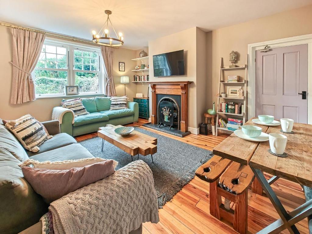 a living room with a blue couch and a fireplace at 2 Bed in Morpeth oc-l35201 in Morpeth