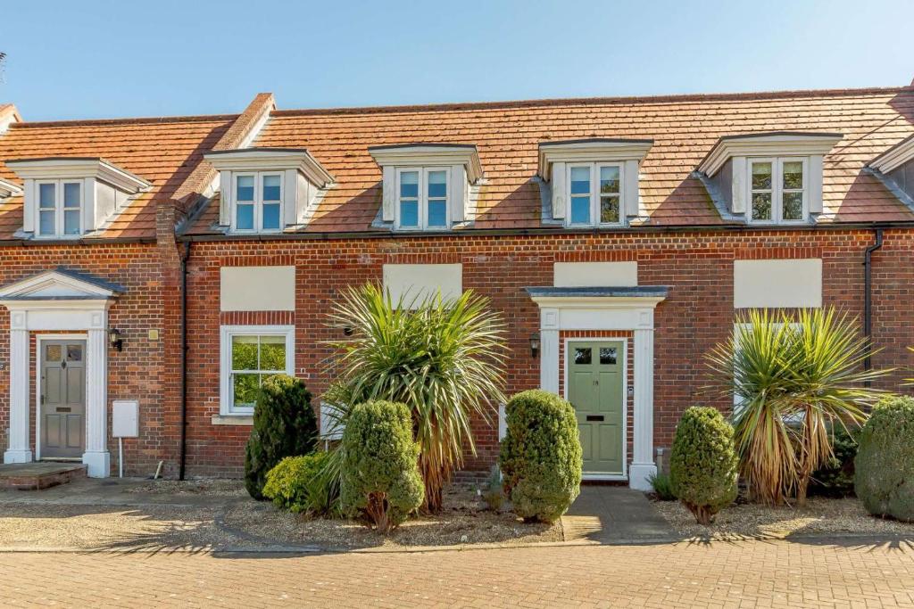 a red brick house with plants in front of it at 3 Bed in Reydon oc-a36049 in Reydon