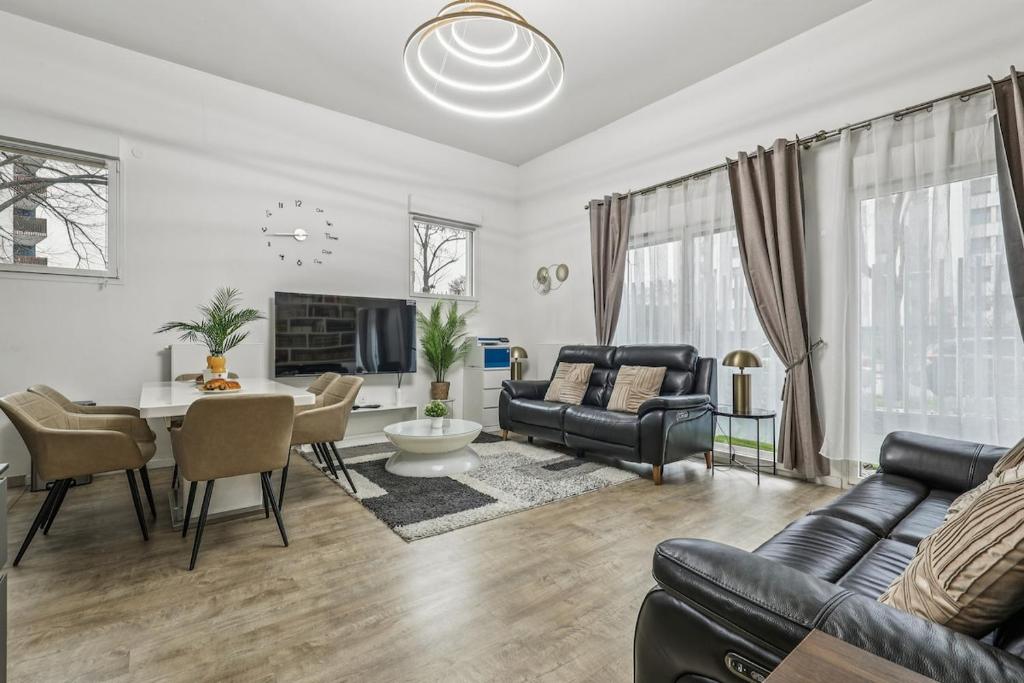 a living room with a couch and a table at NK Apartment in Bobigny in Bobigny