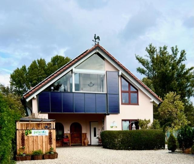 a house with a large window on top of it at Black & White in Ilmmünster