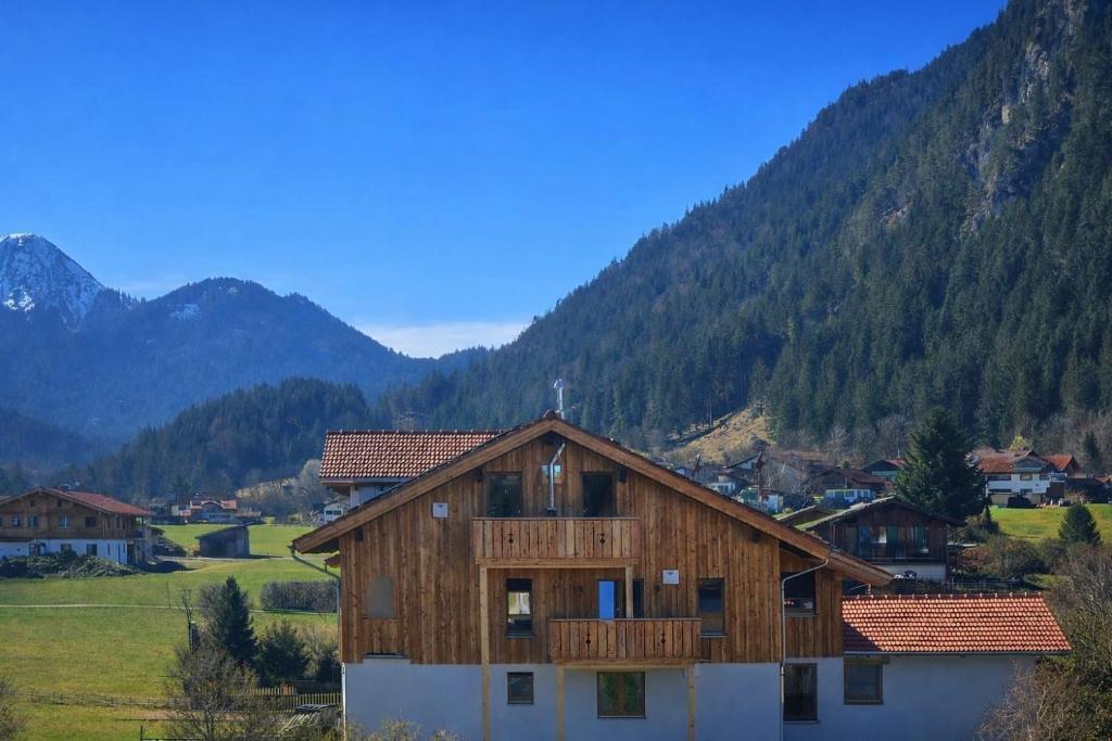 a wooden house in the middle of a mountain at Landhaus Sonnenwang in Pfronten
