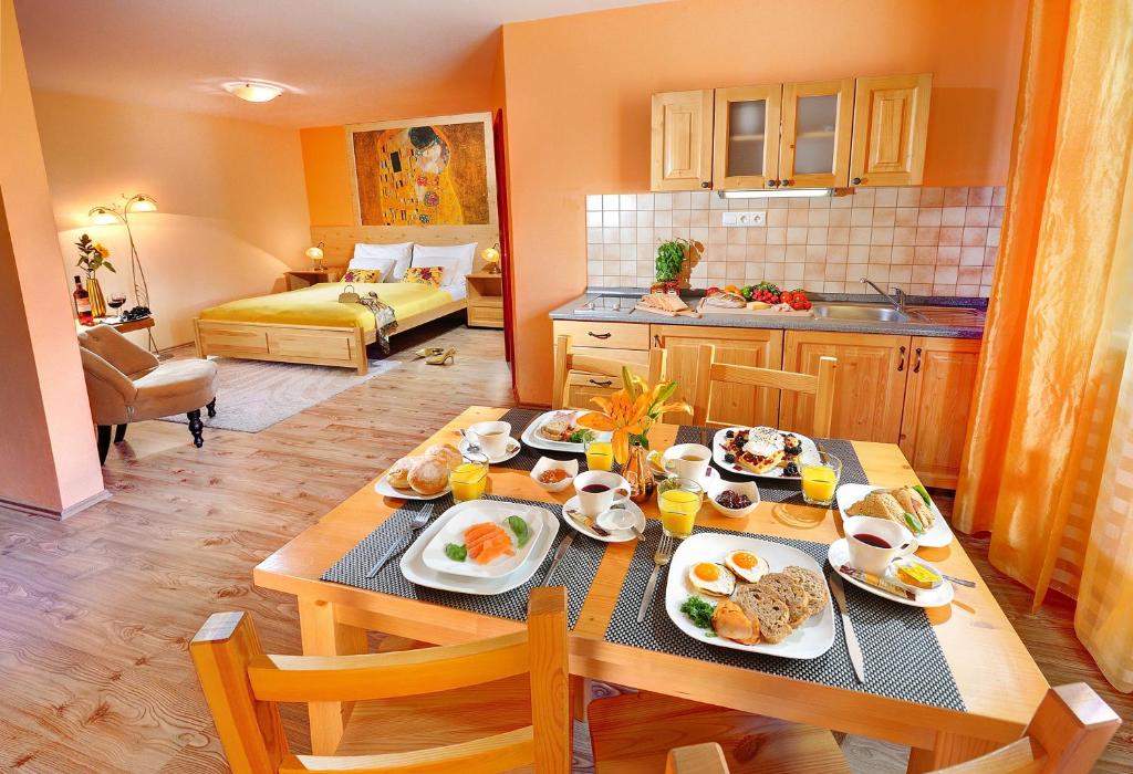 a kitchen with a table with breakfast foods on it at Apartmány Renomal in Vysoke Tatry - Tatranska Lomnica.
