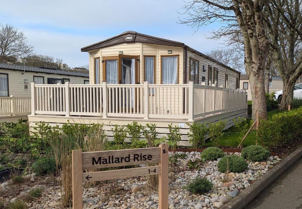 a small house with a sign in front of it at M6 Mallard Rise in Goodrington