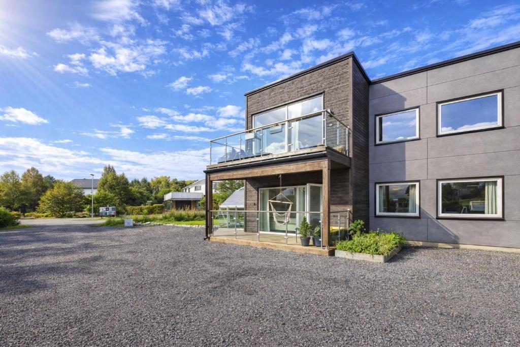 an image of a house with a driveway at Nordic Comfort Suite with Hot Tub in Storeidet