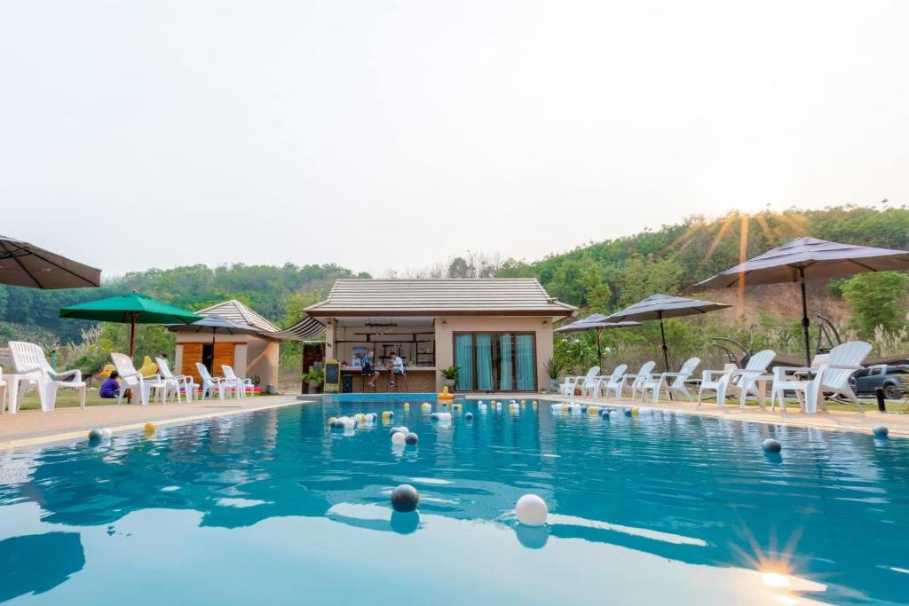 a group of people in a swimming pool at villa Tip in Ban Na An
