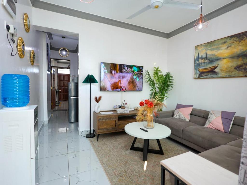 a living room with a couch and a table at Cosy 1 Bedroom in CBD Mombasa with City View in Mombasa