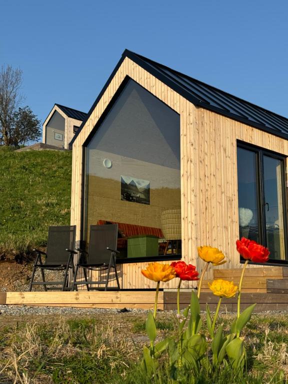 a tiny house with two chairs and a table at Charming tiny house with panorama view in Sandane
