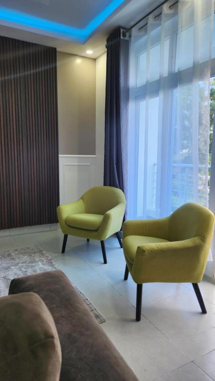 a living room with two chairs and a couch at vale mombasa nyali in Mombasa