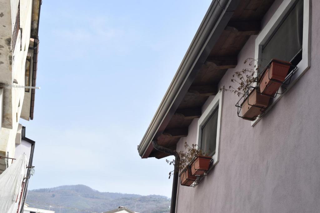 two windows on a building with flower boxes on it at Il Borgo civ 25 in Paola