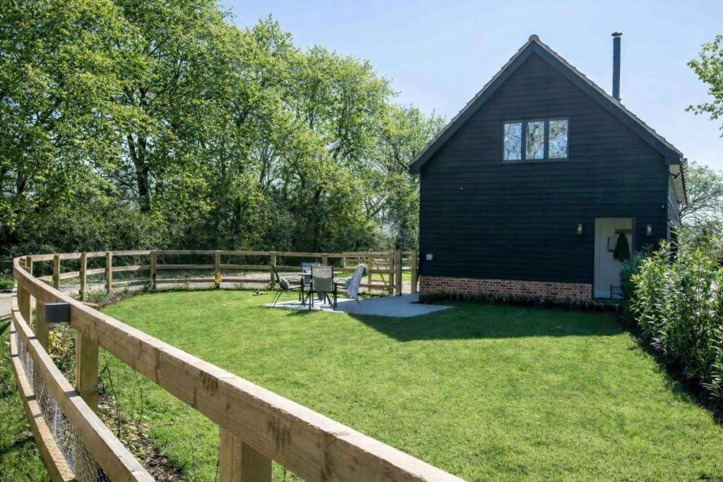 a barn with a yard with a fence at Barney's Barn in Woodbridge