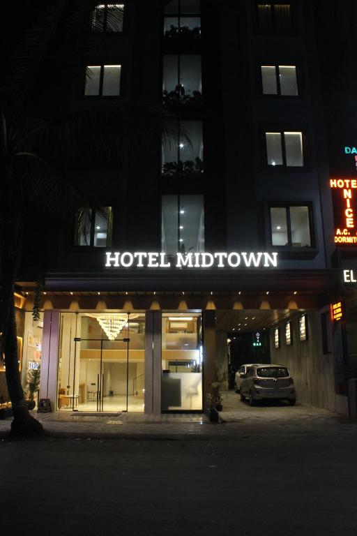 a hotel midtown is lit up at night at Hotel Midtown in Surat
