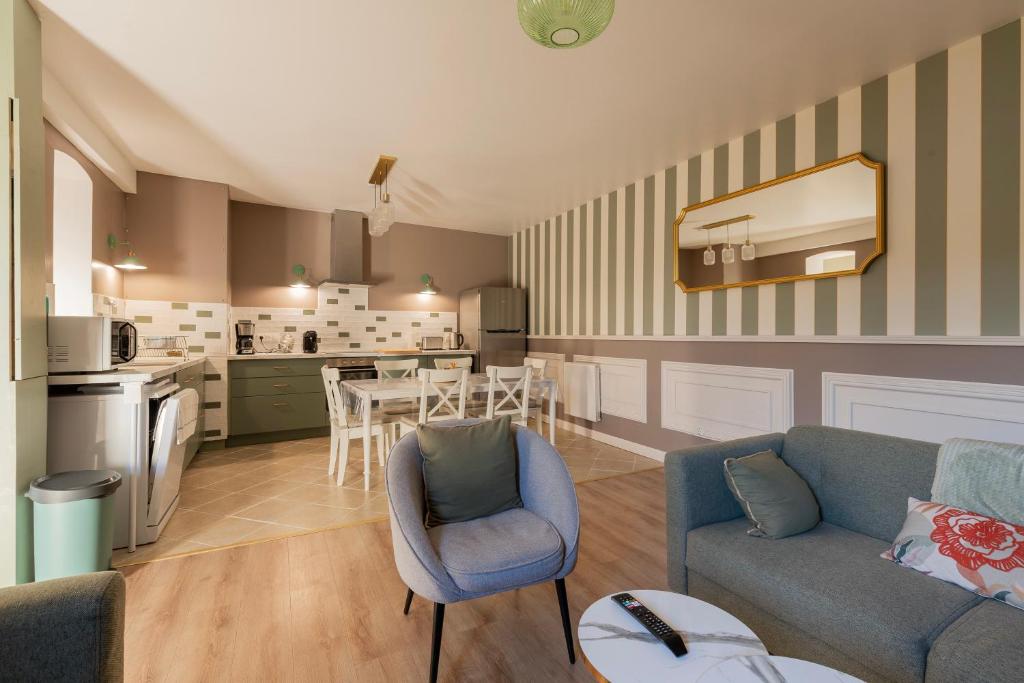 a living room with a couch and a table at La Pause Picarde - Baie De Somme 1 in Franleu