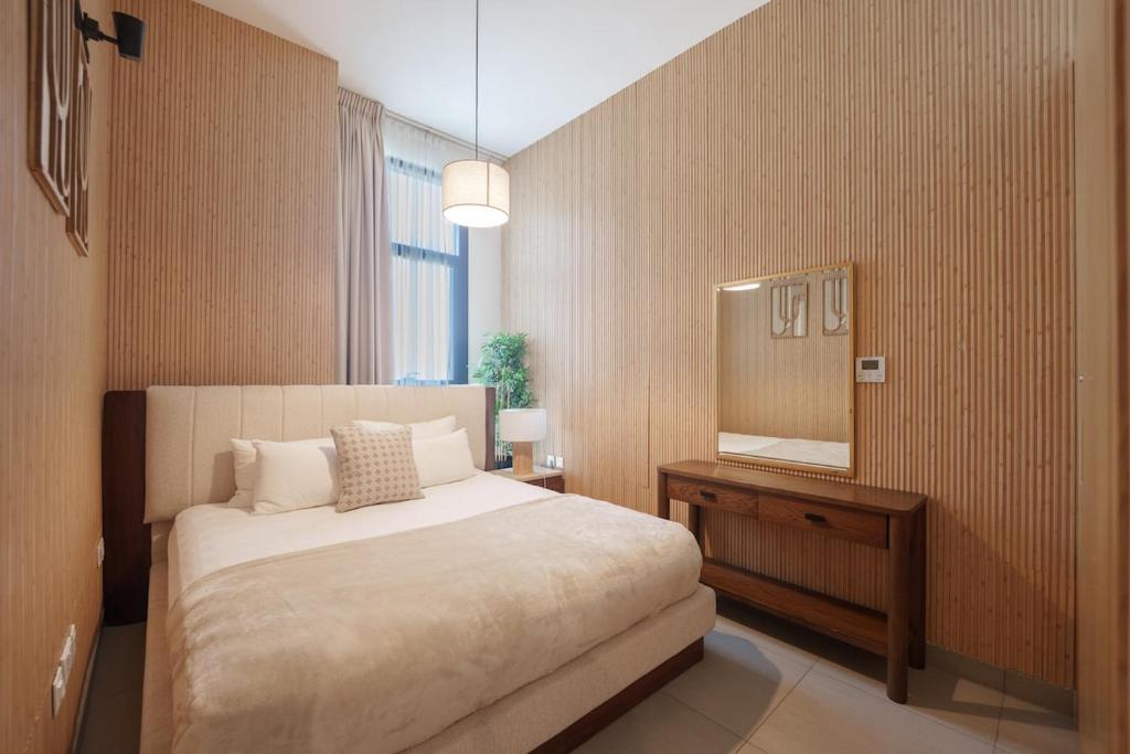 a bedroom with a bed and a mirror at Golden Sunset Luxe 1BR CB2-3-RA1-812-1br in Sabkhah