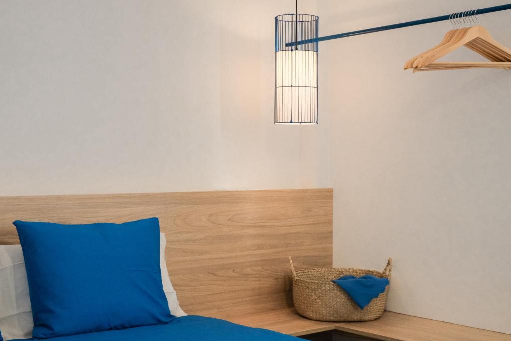 a bedroom with a blue pillow and a basket at Nila 1 by Huskalia in Los Llanos de Aridane