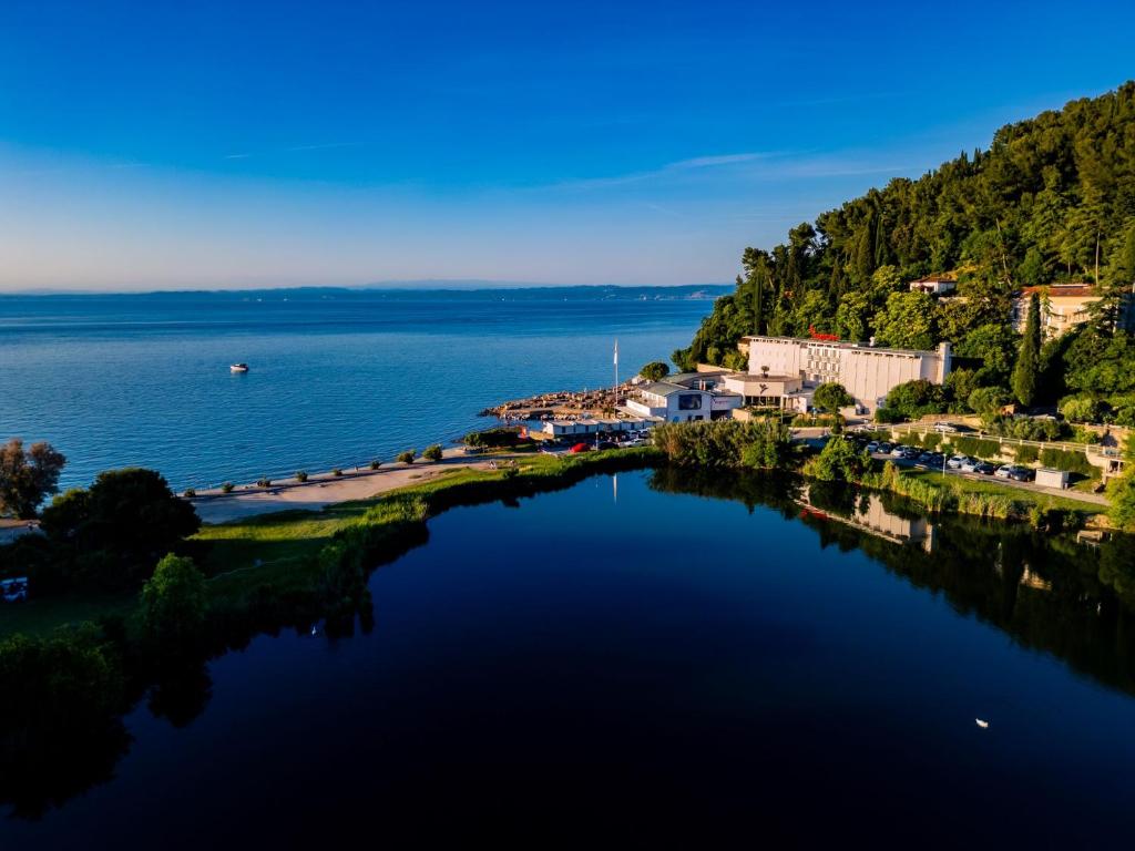 an aerial view of a river with a town at Barbara Piran Beach Hotel in Piran
