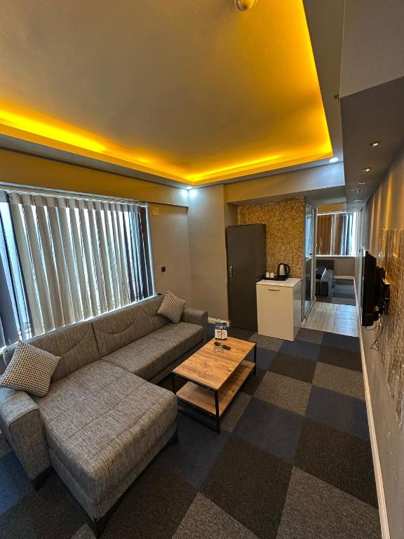 a living room with a couch and a table at Panorama Rezidans Kayseri in Kayseri