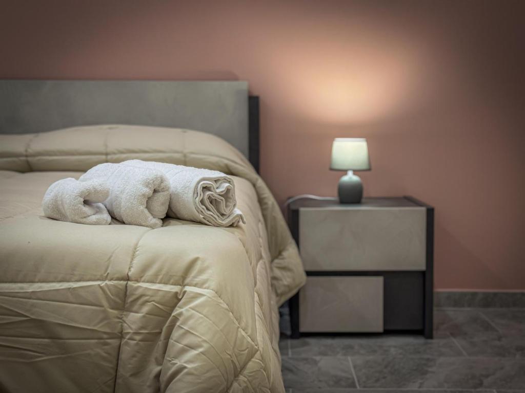 a bedroom with a bed with a towel on it at ToNo House in Paterno