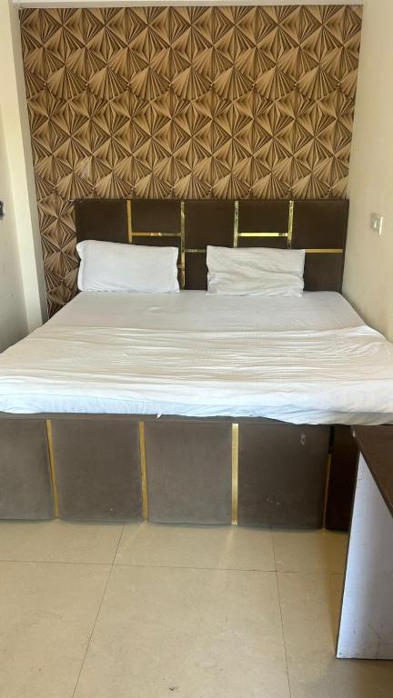 a bed with two pillows on top of it at jai shree hotel in Noida