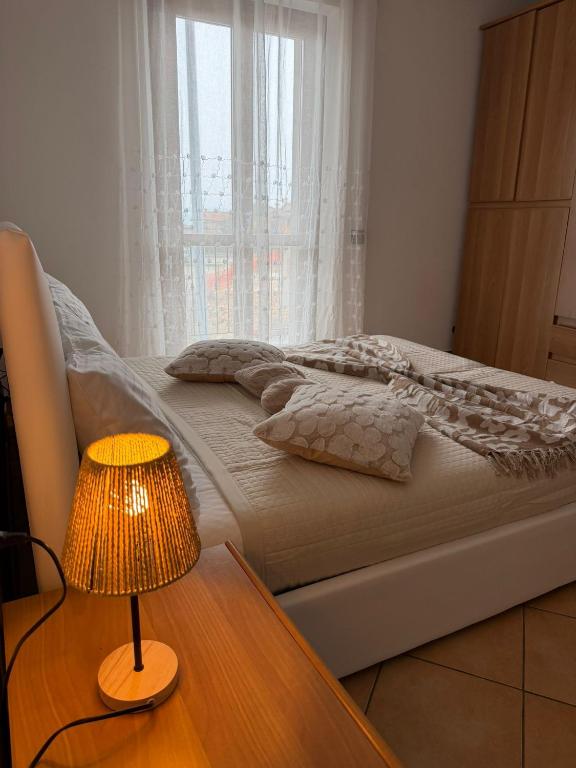 a bedroom with a bed and a table with a lamp at Casa Speranza in Narzole