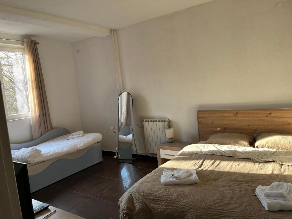 a bedroom with two beds and a window at Center City Stay 2 in Skopje