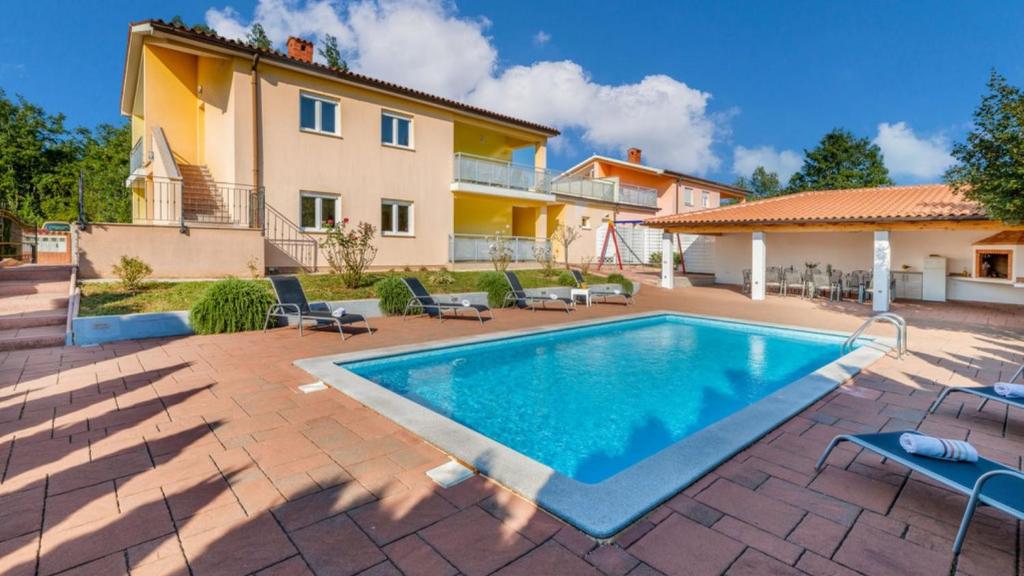 a villa with a swimming pool and a house at Villa Iva by Villas Guide in Pazin