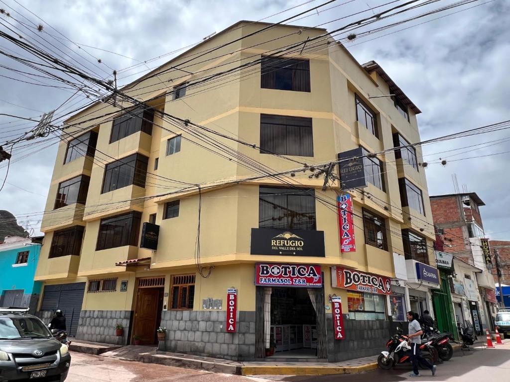 a yellow building on the corner of a street at Refugio del Valle del Sol in Urubamba