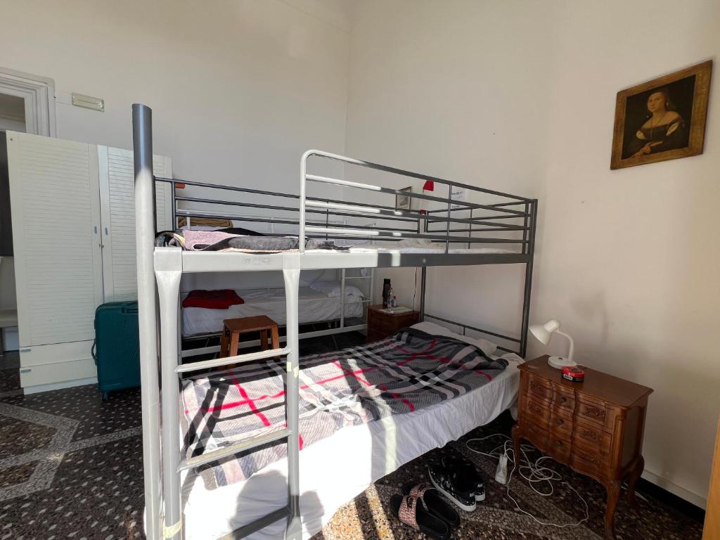 a bedroom with a bunk bed with a ladder at Hostello Genovese in Genoa