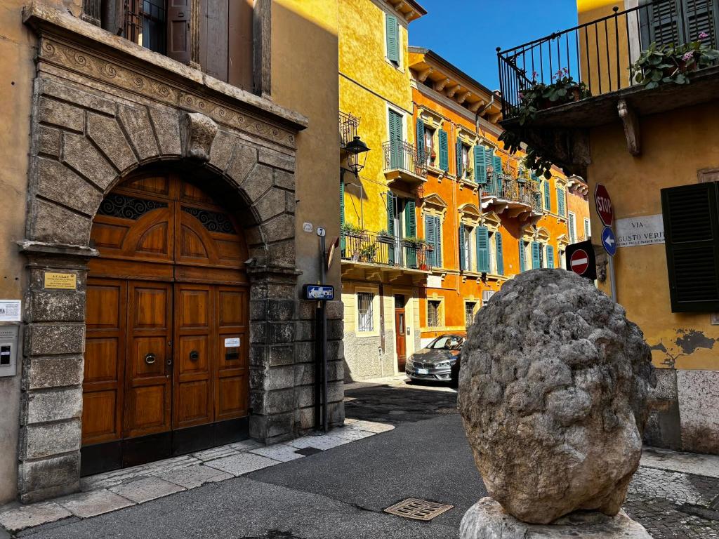 a large rock sitting in front of a building at Protezione della Giovane - female hostel in Verona