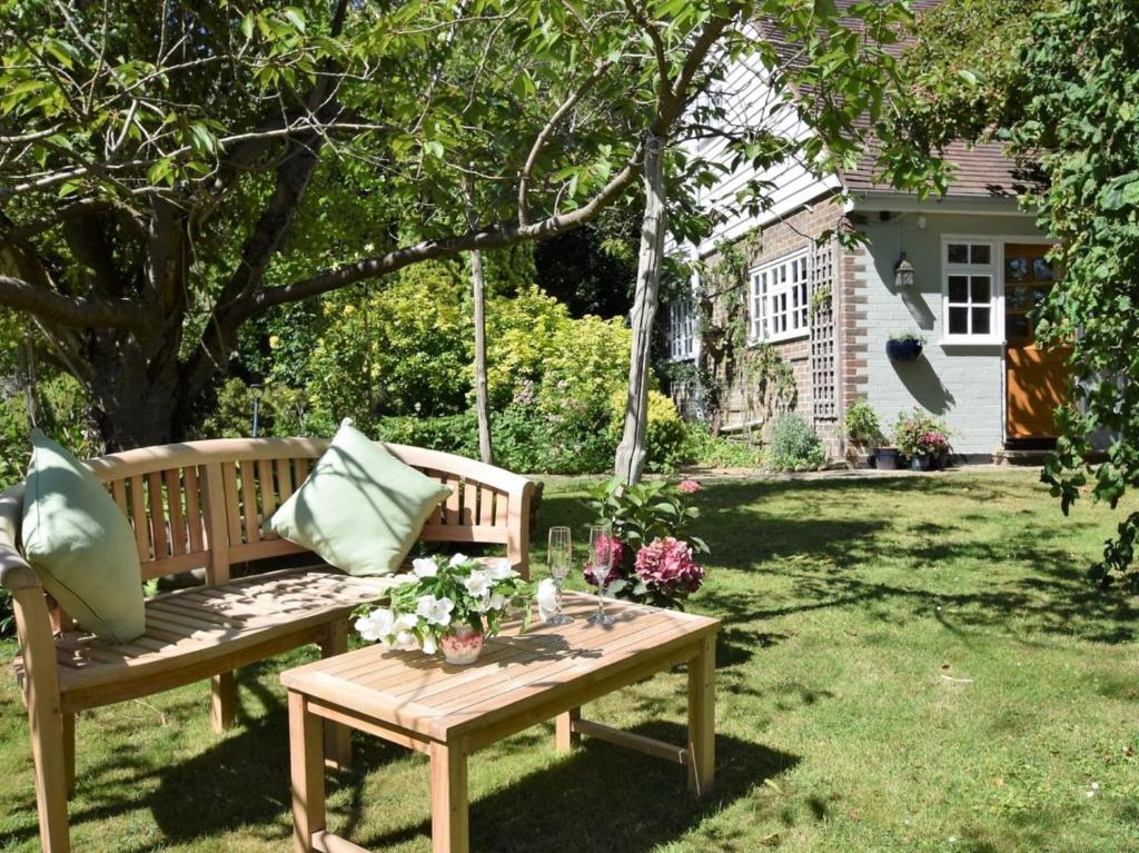 a garden with two benches and a table at 1 Bed in Etchingham oc-62641 in Burwash