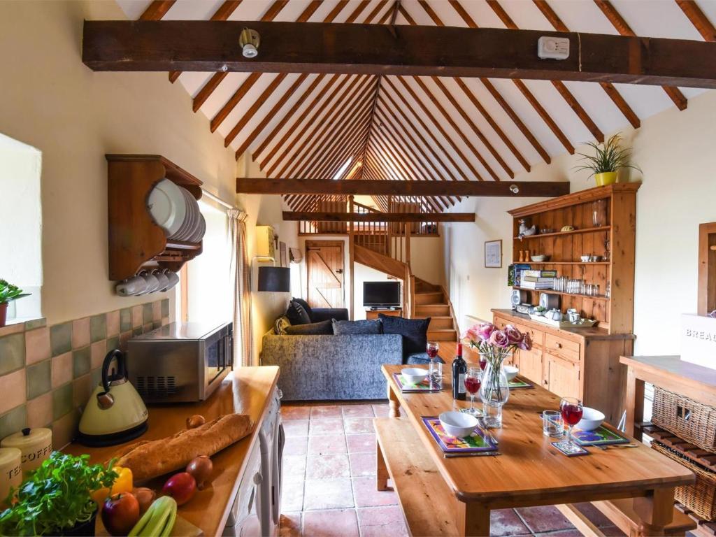 a kitchen and living room with wooden ceilings and a table at 2 Bed in Briston oc-kt009 in Briston