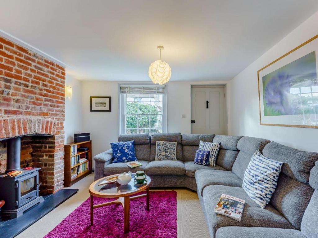 a living room with a couch and a brick fireplace at 3 Bed in Whitstable oc-wcc12 in Whitstable