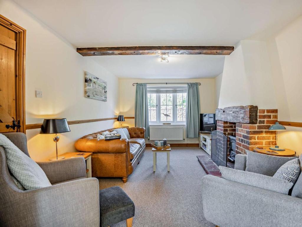 a living room with a couch and a fireplace at 3 Bed in Kings Lynn oc-65596 in Heacham