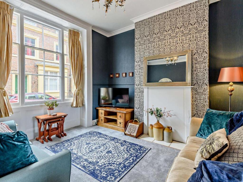 a living room with a couch and a fireplace at 3 Bed in Skegness oc-83461 in Wainfleet All Saints