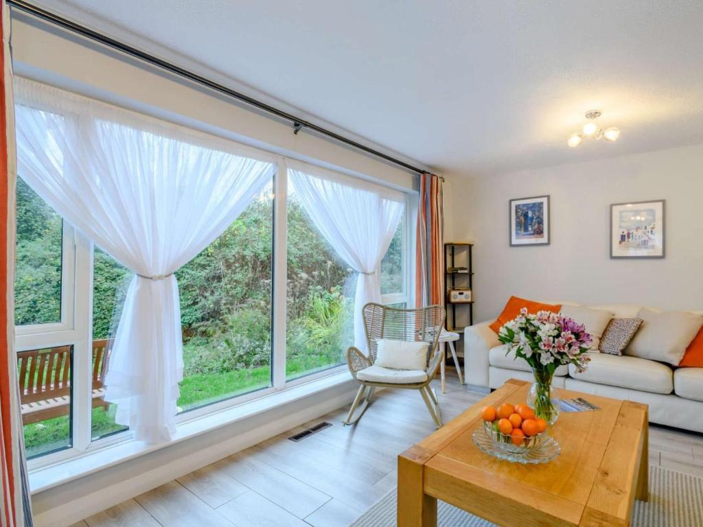 a living room with a large window and a couch at 3 Bed in Sheringham oc-86262 in Sheringham