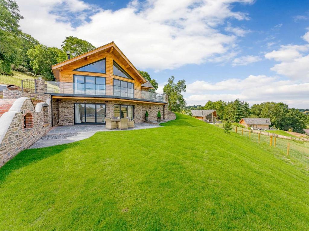 a house on a hill with a green lawn at 3 Bed in Montgomery oc-88641 in Llandyssil