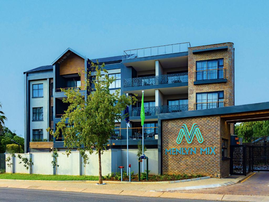 a building with a sign on the side of it at Menlyn Mix in Pretoria