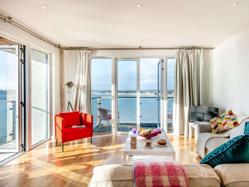 a living room with a view of the ocean at 2 Bed in Colchester oc-90382 in Saint Osyth