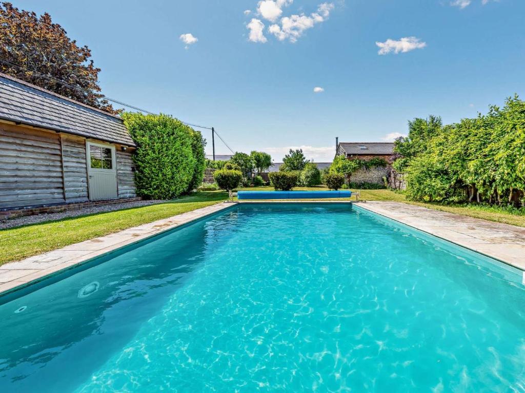 a swimming pool with blue water in a yard at 1 Bed in Chichester oc-77402 in Eastergate