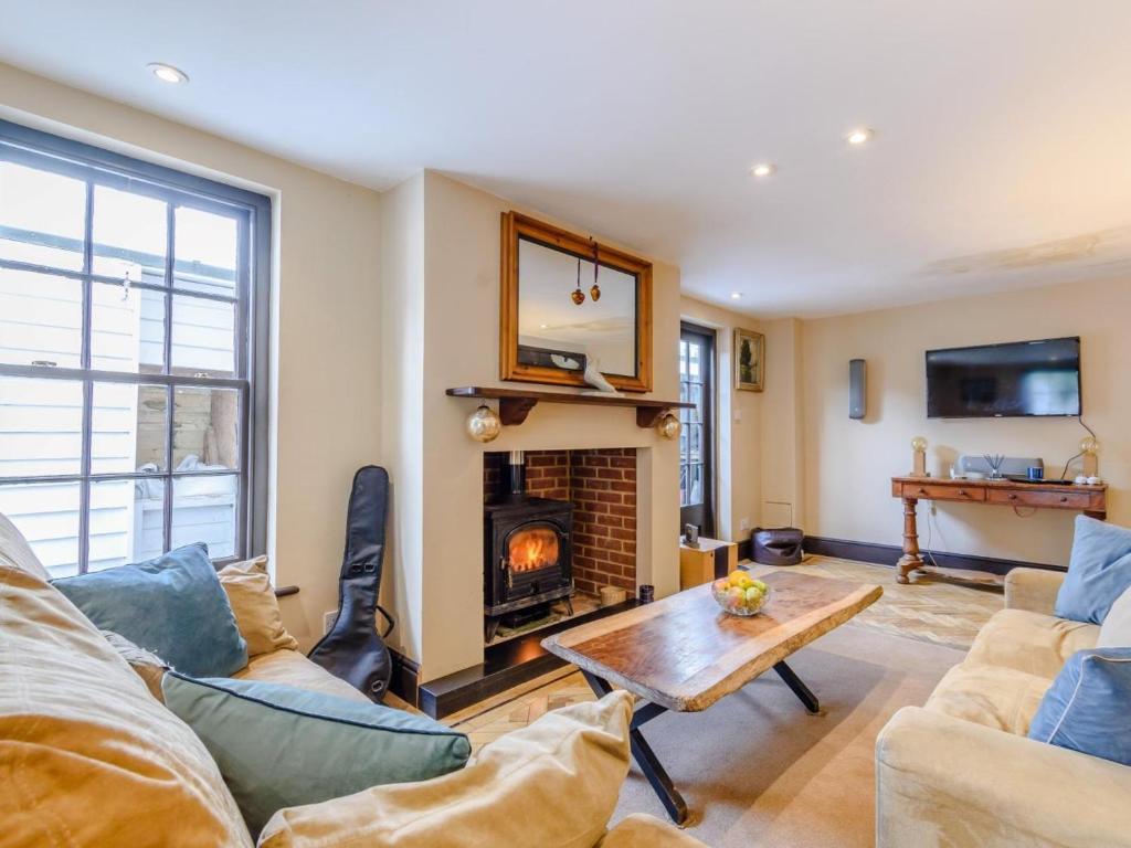 a living room with a couch and a fireplace at 3 Bed in Faversham oc-78880 in Faversham