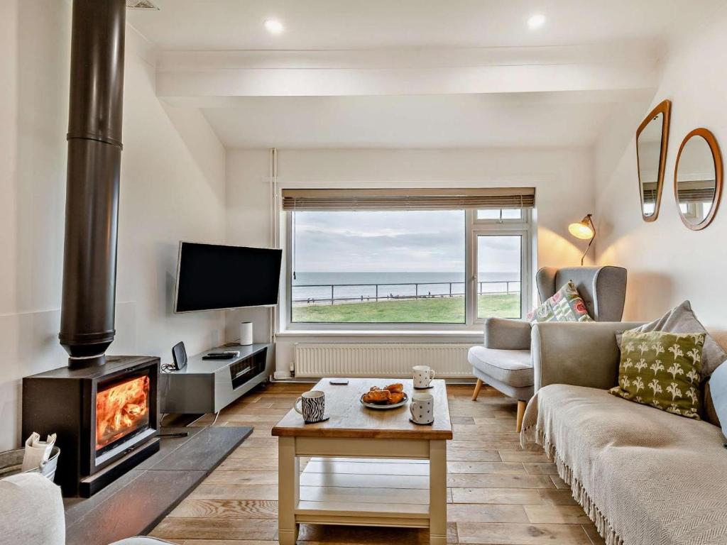 a living room with a couch and a fireplace at 2 Bed in Norwich oc-75391 in Bacton