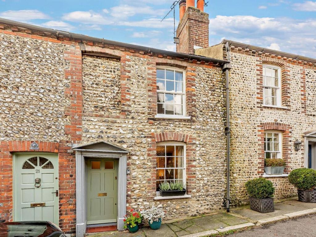 a brick building with a green door and windows at 2 Bed in Arundel oc-89671 in Arundel