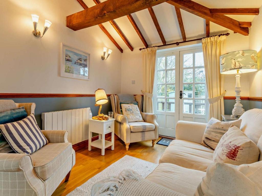 a living room with a couch and chairs and a window at 3 Bed in Norwich oc-85528 in Thurgarton
