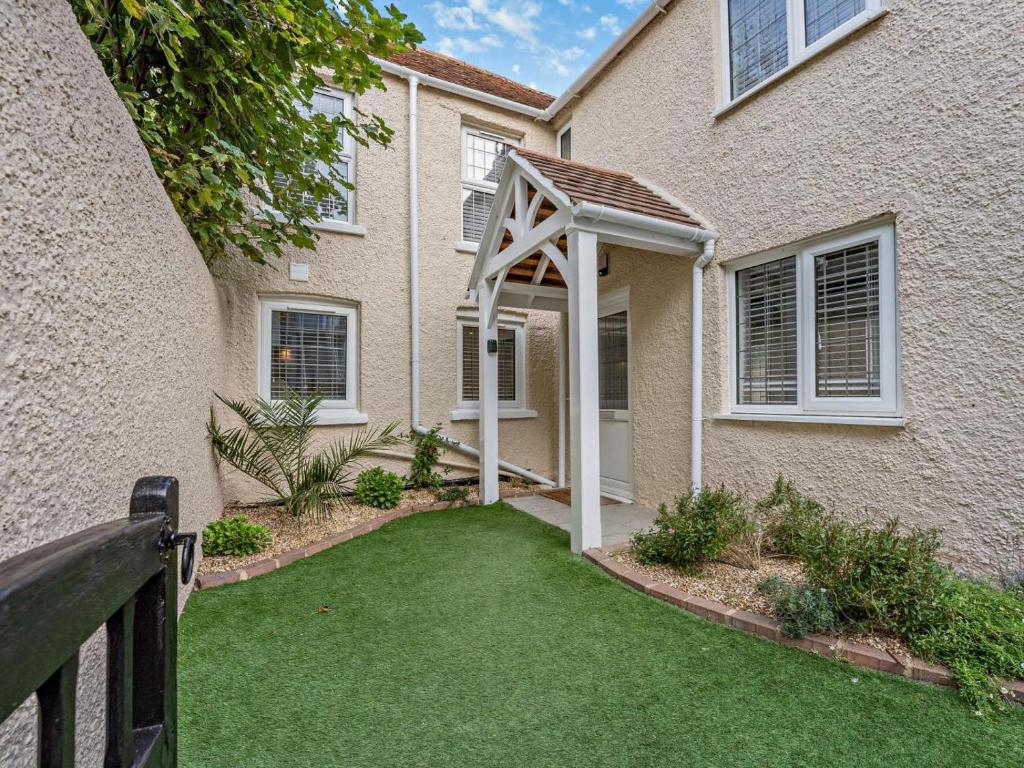 a house with a lawn in front of it at 3 Bed in Bognor Regis oc-93447 in Bognor Regis