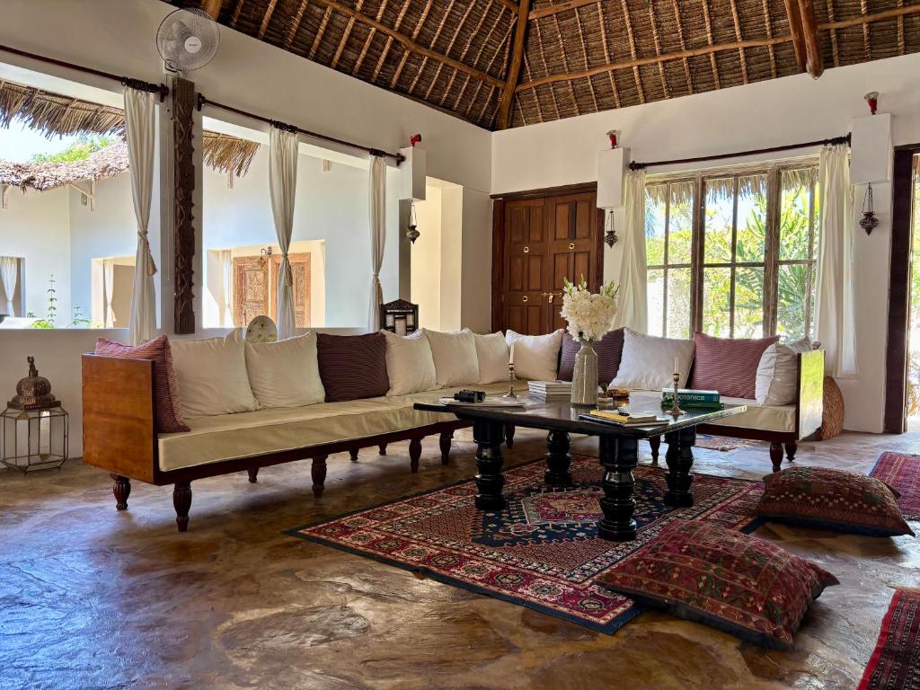a living room with a couch and a table at Flower House in Malindi