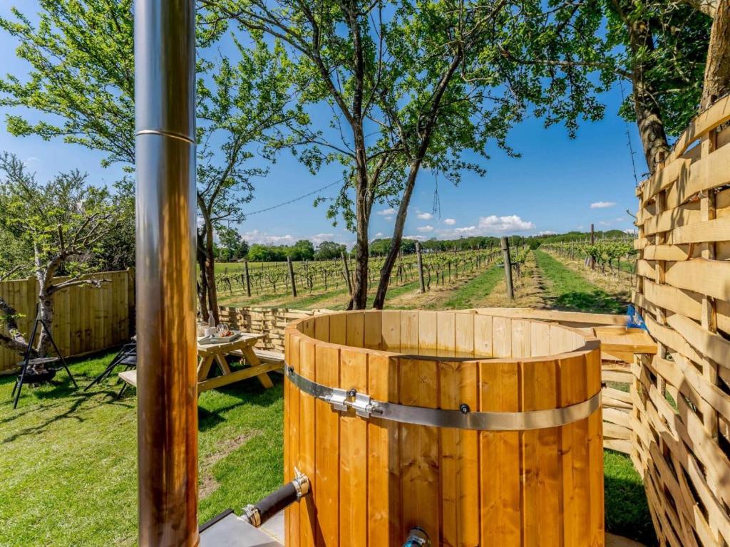 a wooden barrel with a view of a vineyard at 1 Bed in Ashford oc-82527 in Biddenden